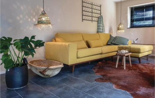 a living room with a yellow couch and a table at Amazing Home In Leende With Wifi in Leende