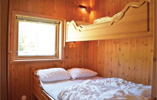 a bedroom with a bunk bed and a window at Holde in Hemsedal