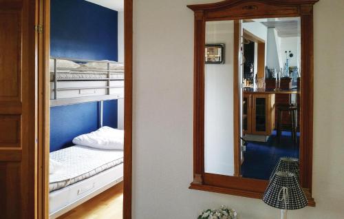 a mirror in a room with a bed at Villa Adenäs in Åsa