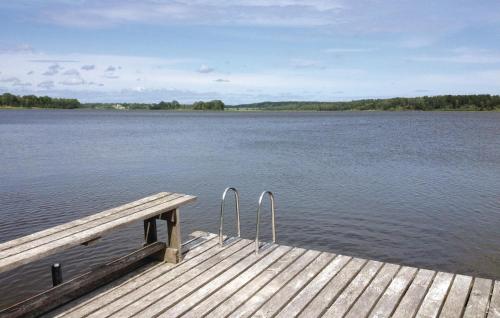 a dock on a lake with a view of the water at 2 Bedroom Lovely Home In Dals Rostock in Dals Rostock