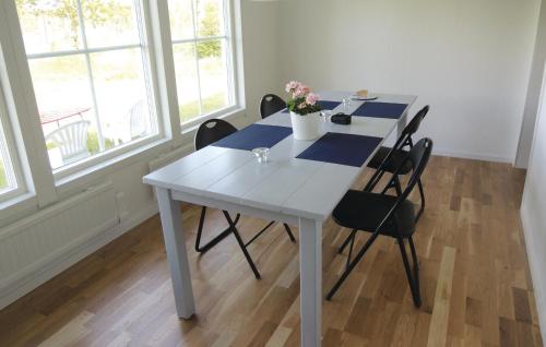a white table with chairs in a room with windows at Holiday Home Hyltebruk - 06 in Hyltebruk