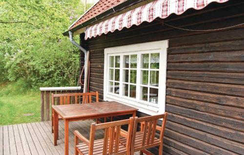 a wooden deck with a table and chairs on a cabin at Holiday Home Loaklev Vetlanda Ii in Loaklev