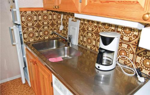 a kitchen with a sink and a coffee maker on a counter at Holiday Home Loaklev Vetlanda Ii in Loaklev