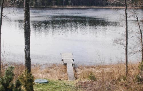 a small dock in the middle of a lake at Cozy Home In Dingle With Lake View in Dingle