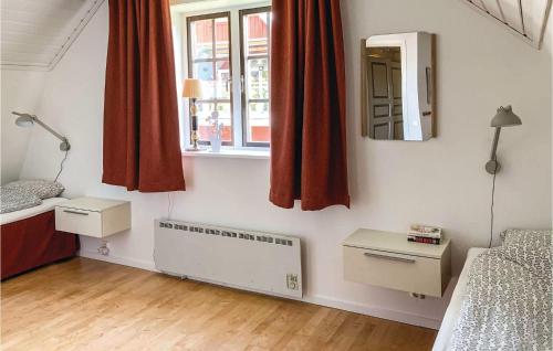 a small room with a bed and a window at Holiday Home Vaggeryd 61 With Sauna in Hok