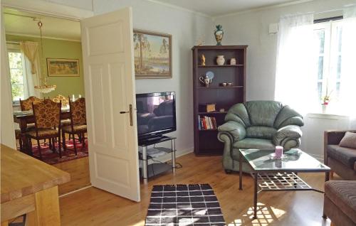 a living room with a couch and a television at Holiday Home Kallinge With A Fireplace 07 in Möljeryd