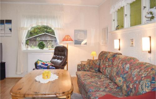 a living room with a couch and a coffee table at One-Bedroom Holiday Home In Vittsjo in Vittsjö