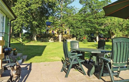 a dog sitting next to a table and chairs at Holiday Home Kallinge With A Fireplace 07 in Möljeryd