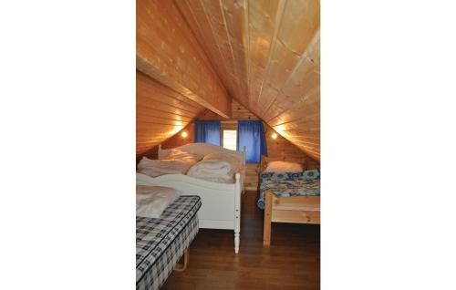 a room with two beds in a tiny house at 3 Bedroom Lovely Home In Bstad in Unnstad