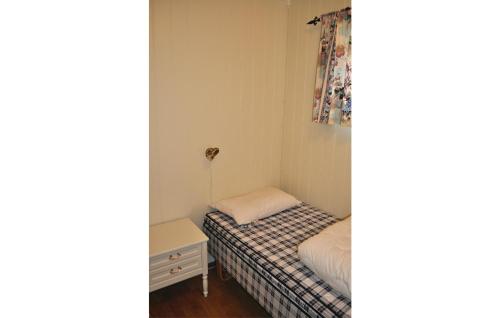 a small bedroom with a small bed and a window at Stunning Home In Bøstad With Wifi in Unstad