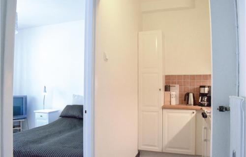 a bedroom with a bed and a door leading to a bathroom at Amazing Apartment In Ystad With Kitchen in Ystad