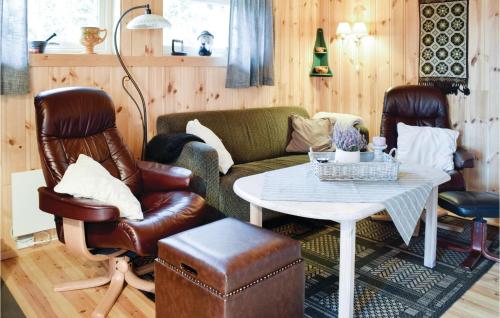 a living room with a couch and a table at Two-Bedroom Holiday Home In Sjusjoen in Sjusjøen