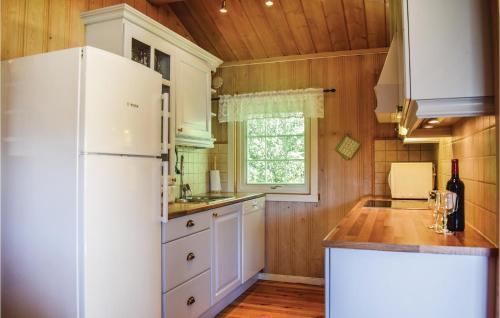 a kitchen with a white refrigerator and a window at Beitebu in Hemsedal