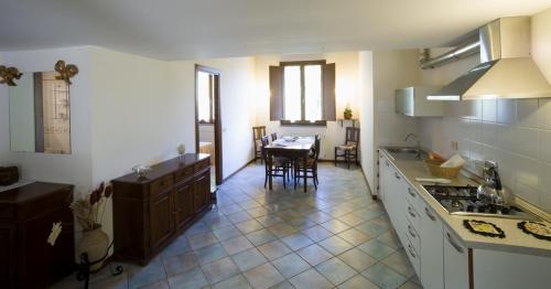 a kitchen with a table and a dining room at San Giorgio Villam in Orvieto