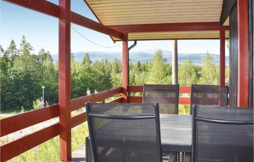 a table and chairs on a porch with a view at Awesome Home In Lofsdalen With Kitchen in Lofsdalen