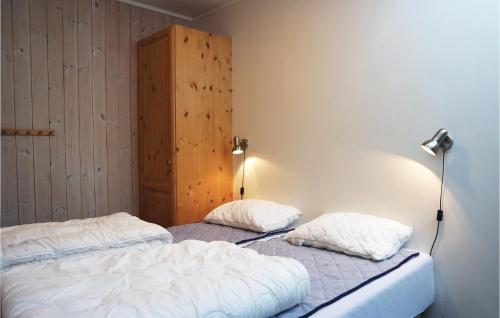 two twin beds in a room with a lamp at 2 Bedroom Awesome Apartment In Hemsedal in Hemsedal