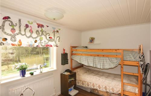 a bedroom with a bunk bed and a window at Amazing Home In Strmstad With 2 Bedrooms And Wifi in Lommeland