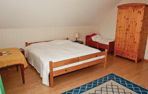 a bedroom with a bed and a chair and a table at Holiday Home Baggekulla Blidsberg in Tomten