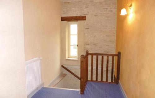 a hallway with a wooden staircase with a window at 4 Bedroom Awesome Home In Chicheboville in Chicheboville