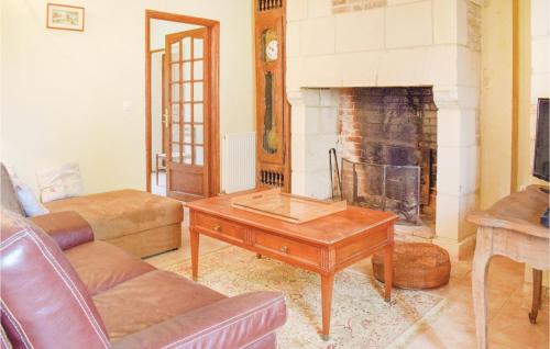 a living room with a couch and a fireplace at 4 Bedroom Awesome Home In Chicheboville in Chicheboville