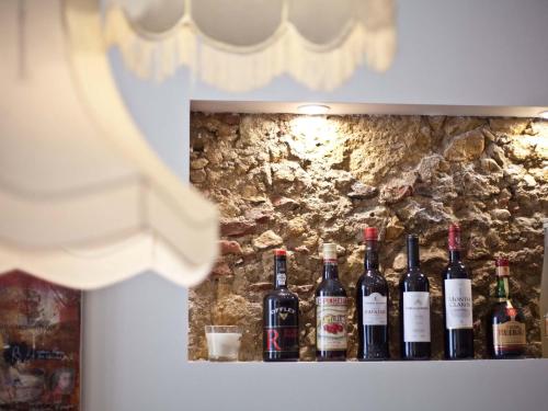 a shelf with a bunch of wine bottles on it at The ART INN Lisbon in Lisbon