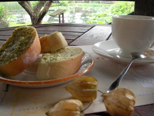 a plate of bread and a cup of coffee on a table at Lotus Hostel Beicheng Zhuang in Luodong