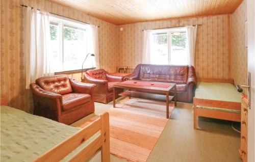 a living room with leather furniture and a table at Beautiful Home In Fegen With 1 Bedrooms And Wifi in Fegen