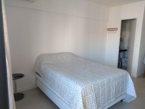 a bedroom with a bed in a white room at Apartamento de alto luxo. in Maceió