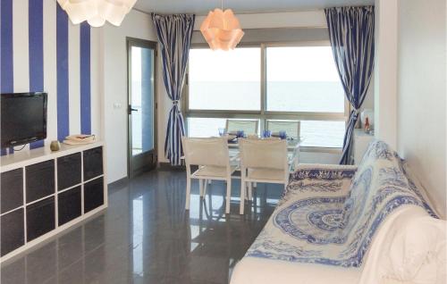 a bedroom with a bed and a dining room with the ocean at Beach Front Apartment in San Blas