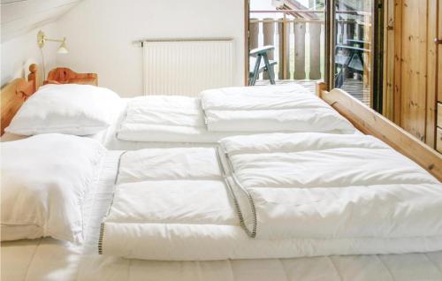 a group of white beds in a room at Ferienhaus 26 In Kirchheim in Kirchheim