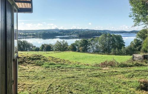 a view of a field and a lake from a house at 2 Bedroom Amazing Home In Hedekas in Hedekas
