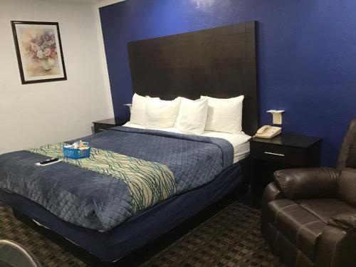 a hotel room with a bed and a couch at Budget Inn & Suites in Oklahoma City