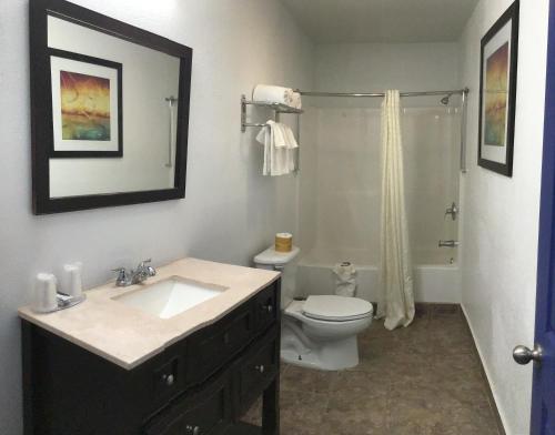 a bathroom with a sink and a toilet at Budget Inn & Suites in Oklahoma City
