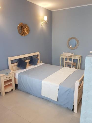 a bedroom with two beds and a table and chairs at Luxury Studio Anis 1 in Mamaia Sat/Năvodari