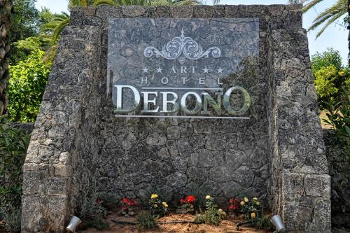 an entrance sign at the entrance of a disney park at Art Hotel Debono in Gouvia