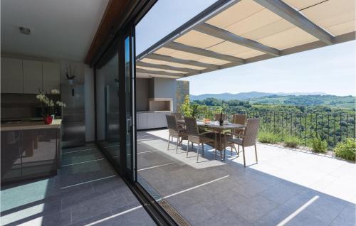 an open kitchen and dining room with a table and chairs at Gorgeous Home In Dobrovo V Brdih in Dobrovo