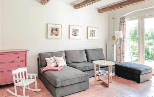 a living room with a couch and a table at Cozy Home In Gammelby With Sauna in Gammelby