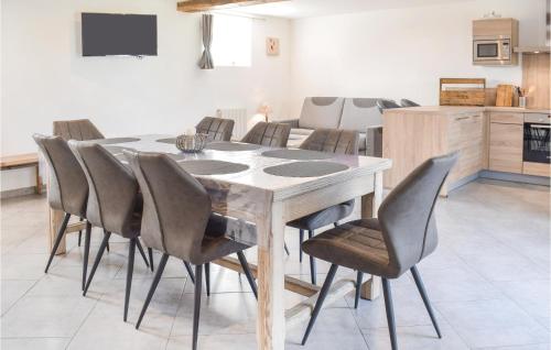 a dining room with a table and chairs at 3 Bedroom Stunning Home In Sainteny in Sainteny
