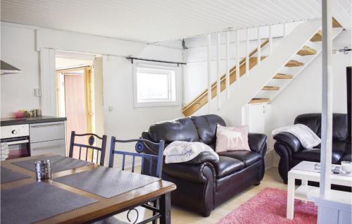 a living room with two leather chairs and a table at 2 Bedroom Gorgeous Home In Jämjö in JÃ¤mjÃ¶