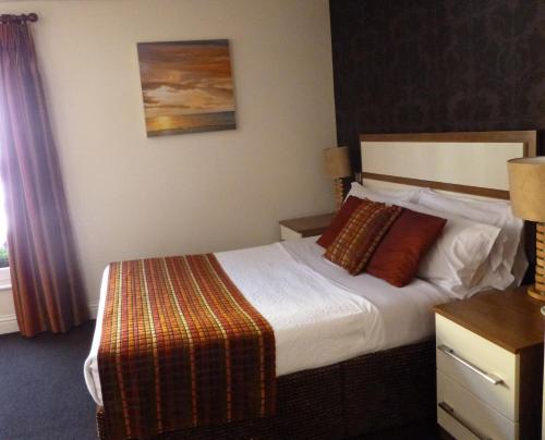 a hotel room with a bed and a window at The White Lady Hotel in Kinsale