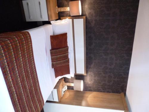 a bedroom with a bed with a mirror at The White Lady Hotel in Kinsale