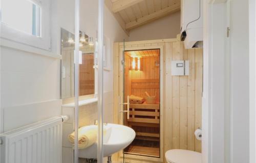 a bathroom with a toilet and a sink at Ferienhausdorf Thale in Thale