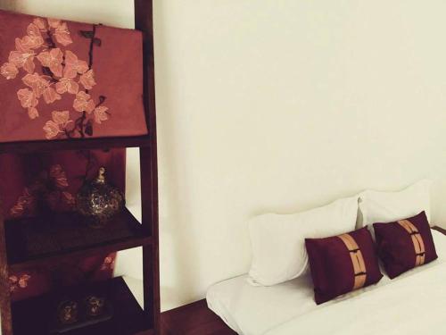 a room with a bed and a shelf with pillows at Chang House in Zhuangwei