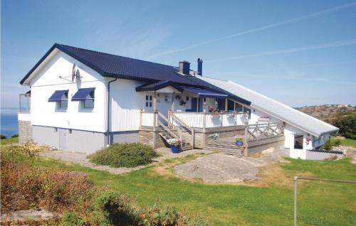 a white house on top of a hill with the ocean at Villa Adenäs in Åsa