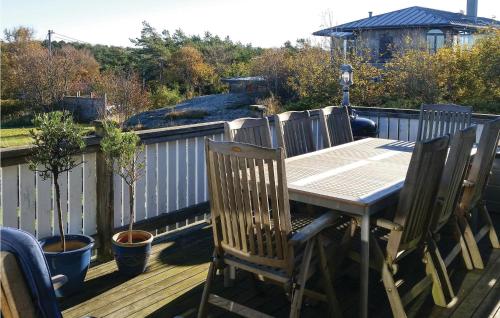 a wooden table and chairs on a deck at Villa Adenäs in Åsa