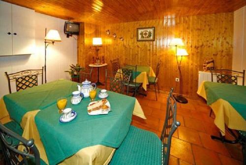 a room with a green table with food on it at Hostal Chinchon in Chinchón