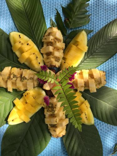 a bunch of bananas on a bunch of leaves at Sahnan Guest House in Bukit Lawang