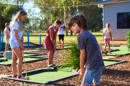 a group of children playing golf on a trampoline at BIG4 Swan Hill in Swan Hill