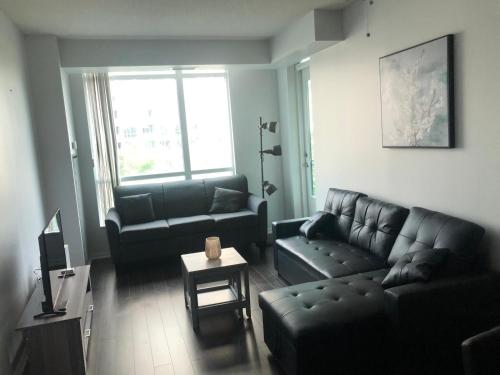 a living room with a couch and a table at Executive 1 Bedroom Condo sleeps 2 in Toronto