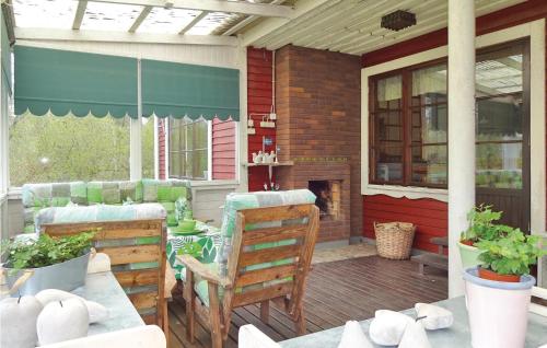 a patio with a table and chairs and a fireplace at 4 Bedroom Amazing Home In Trensum in Trensum
